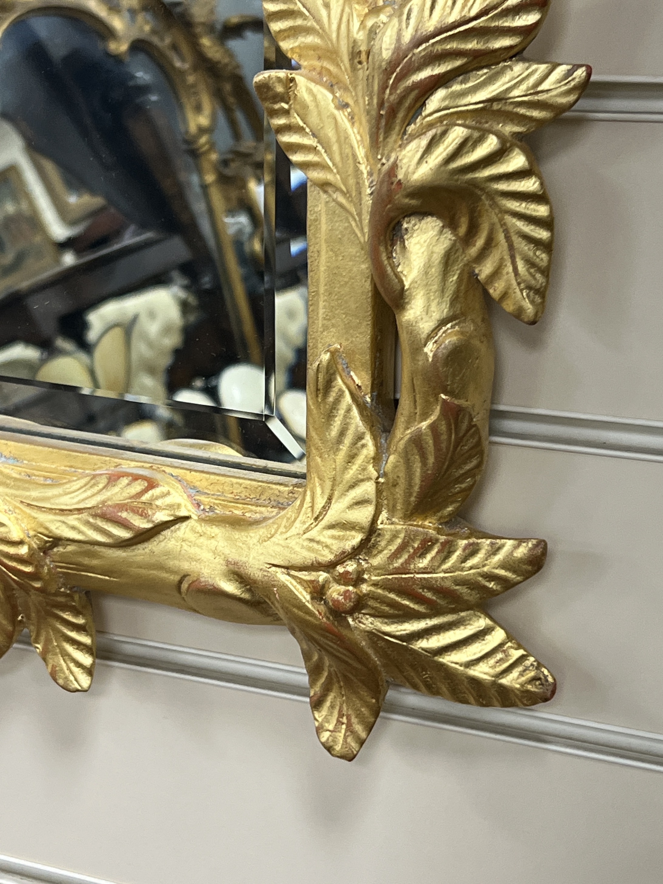 A Victorian style rectangular wall mirror with leaf and branch borders width 65cm, height 85cm.